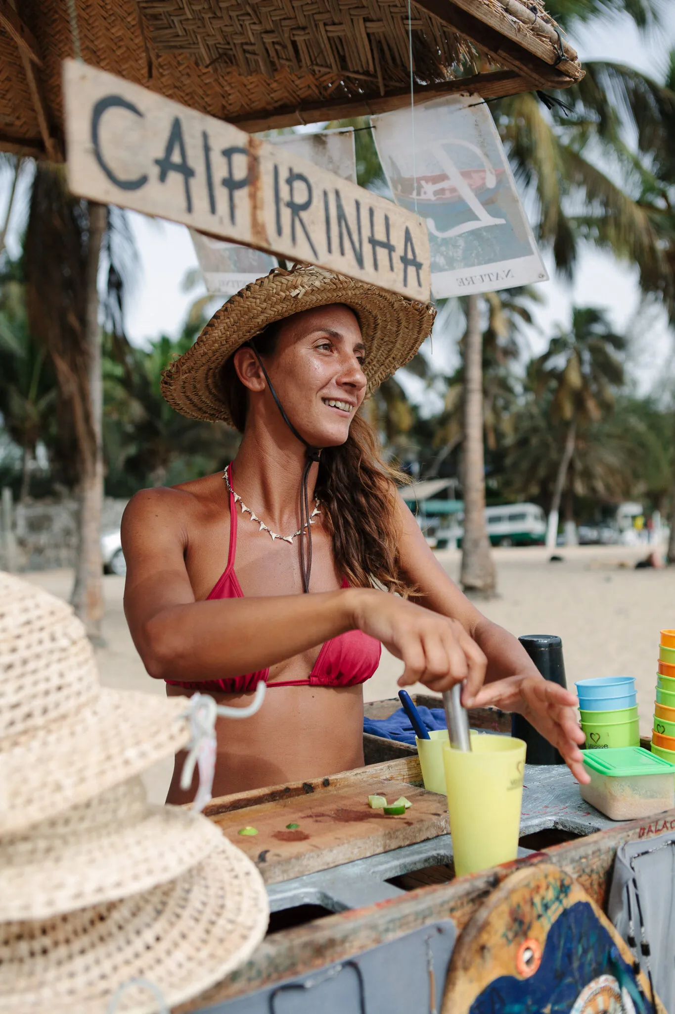 Een vrouw bereidt een caipirinha in een strandbarretje op het eiland Santiago